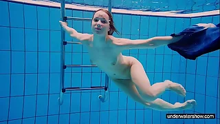 Teen girl Avenna is swimming in the pool